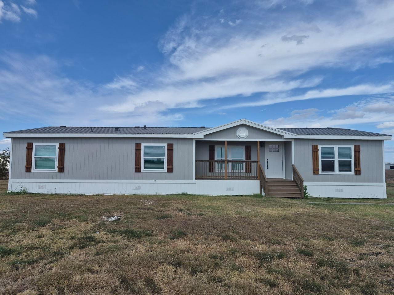 Front exterior of a manufactured home with a covered entrance