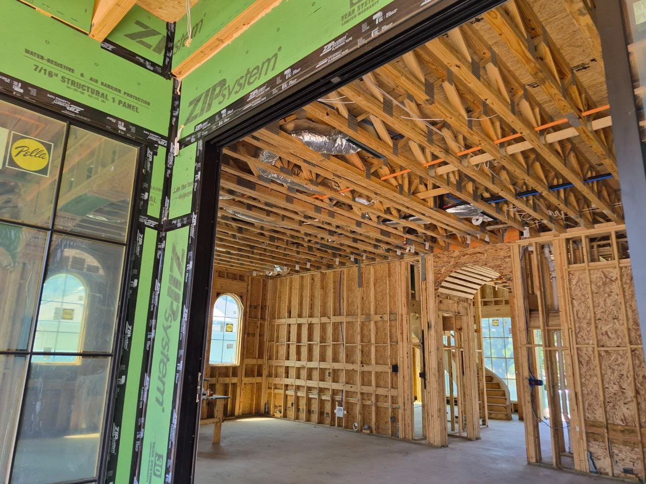 Exposed timber wall and ceiling framing inside a building under construction